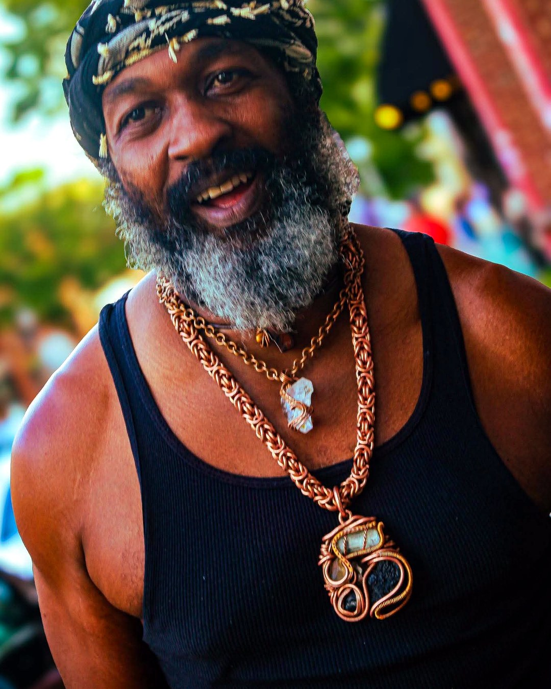 Baker, the copper jewelry artisan, wearing his handmade byzantine chain and wire-wrapped pendant