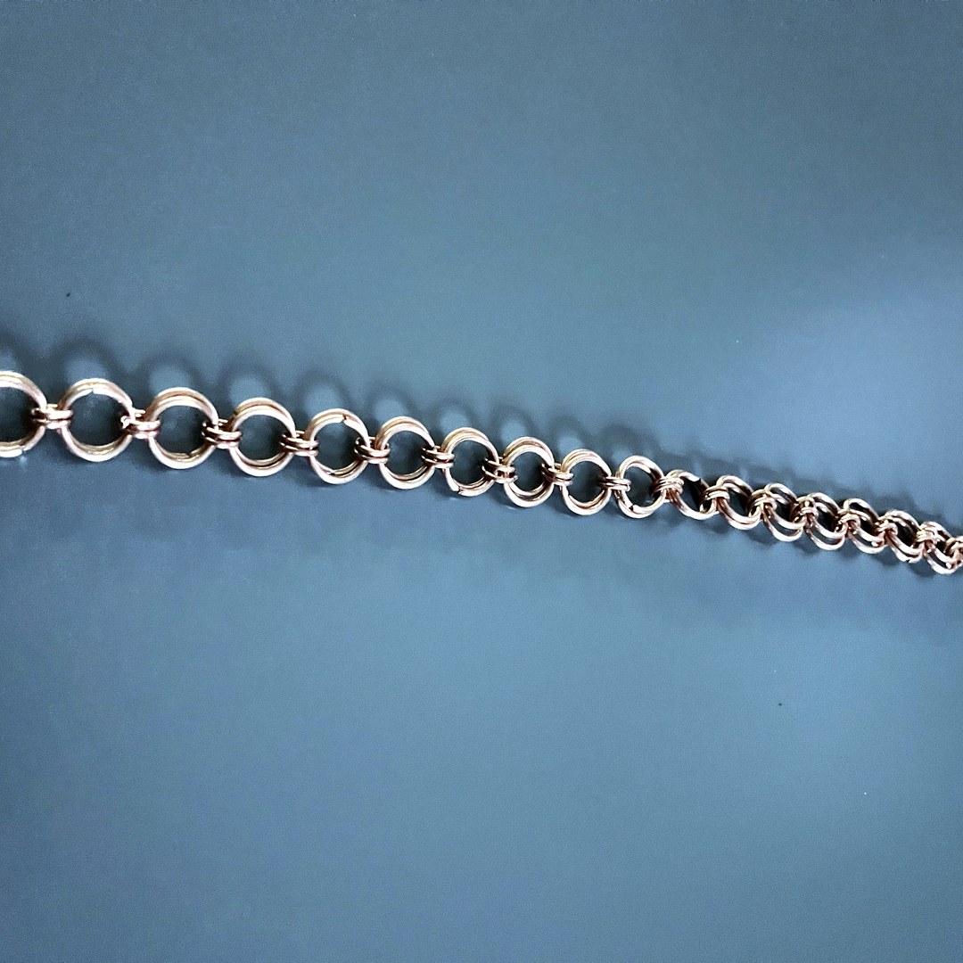 Macro of byzantine weave technique in copper