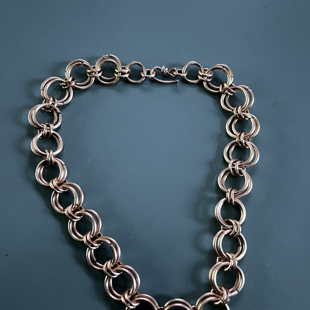 Baker's signature double-loop chainmaille necklace flat-lay
